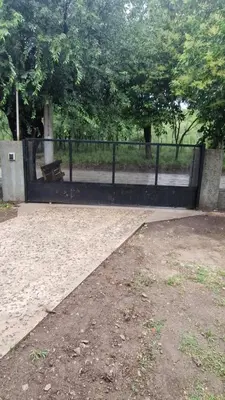 a black fence with a bench in a park at 