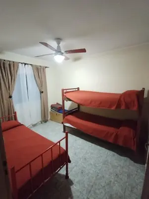 a bedroom with two bunk beds and a ceiling fan at Cabañas La Casita de Fran in Villa del Dique