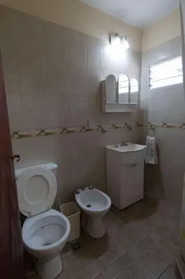 a bathroom with a toilet and a sink at Cabañas La Casita de Fran in Villa del Dique