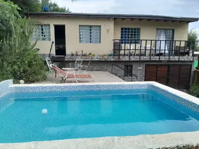 a swimming pool in front of a house at Mateo y Stella in Bialet Massé