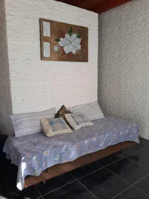 a bed in a room with a painting on the wall at Mateo y Stella in Bialet Massé