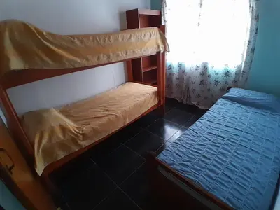 a bedroom with a bunk bed and a small bed at Mateo y Stella in Bialet Massé