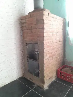 a brick fireplace in a room with a brick wall at Mateo y Stella in Bialet Massé