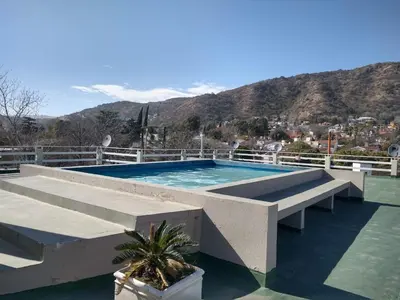 a swimming pool on the roof of a house at Deptos Carlos Paz A in Villa Carlos Paz