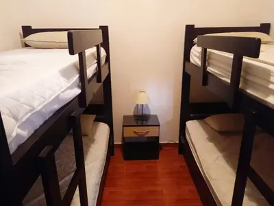two bunk beds in a room with a lamp at Deptos Carlos Paz A in Villa Carlos Paz