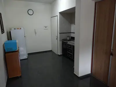 a kitchen with a white refrigerator and a counter at Deptos Carlos Paz A in Villa Carlos Paz