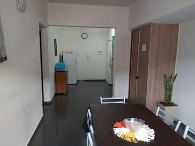 a dining room with a table and a hallway with at Deptos Carlos Paz A in Villa Carlos Paz