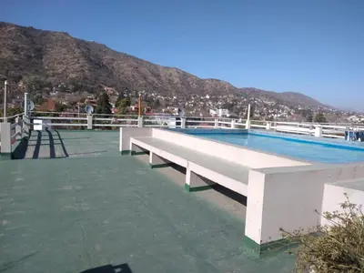 a large swimming pool on top of a building at Deptos Carlos Paz B in Villa Carlos Paz