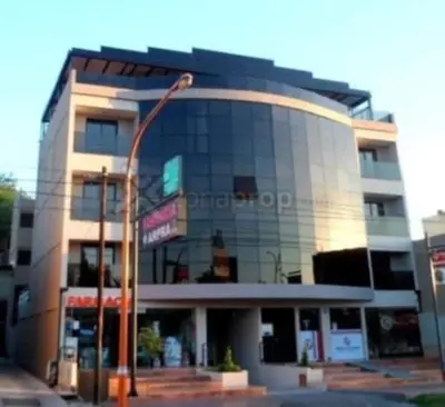 a building with a street light in front of it at Deptos Carlos Paz B in Villa Carlos Paz