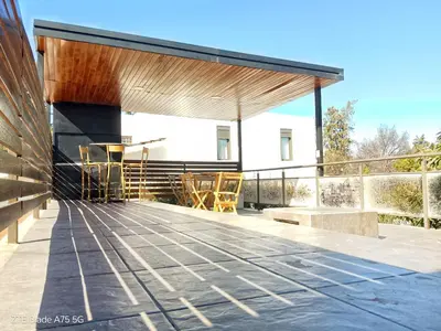 a pavilion with chairs and tables on a patio at Departamento en la Villa in Villa Carlos Paz