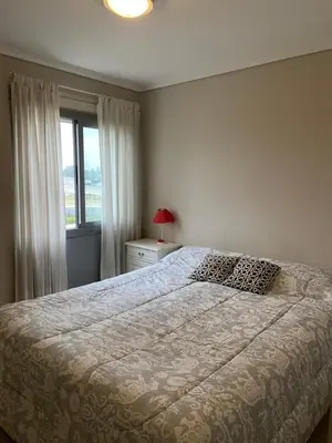 a bedroom with a large bed and a window at Departamento barrio cerrado en altura in Cordoba