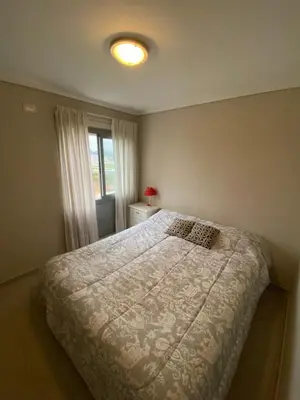 a bedroom with a bed and a window at Departamento barrio cerrado en altura in Cordoba