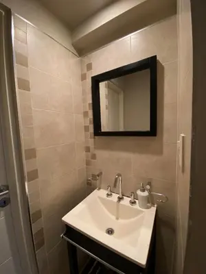 a bathroom with a sink and a mirror at Departamento barrio cerrado en altura in Cordoba