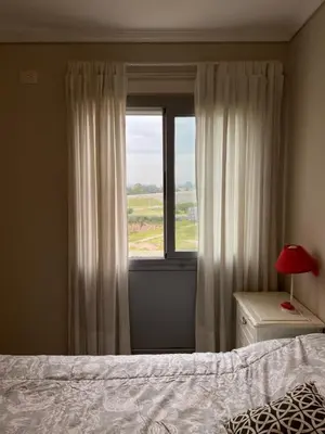 a bedroom with a bed and a window at Departamento barrio cerrado en altura in Cordoba
