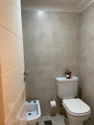 a bathroom with a toilet and a bath tub at Departamento barrio cerrado en altura in Cordoba