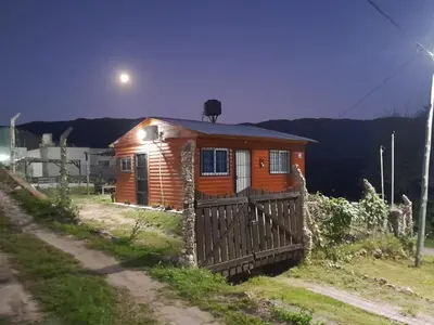 a small wooden house with a wooden gate at Mateo y Stella 2 in Bialet Massé