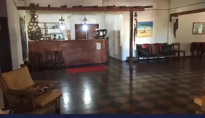 a large living room with a bar in the middle at Hosteria Calamuchita in Villa del Dique