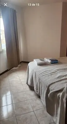 a bedroom with a bed and a window and a tile floor at La Terraza in Cordoba
