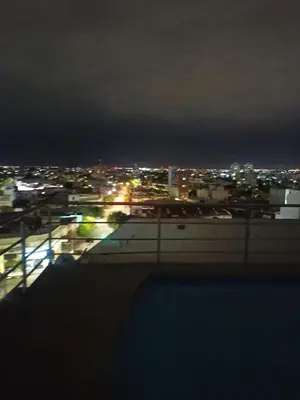 a view of a city at night from a rooftop at La Terraza in Cordoba