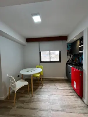 a kitchen with a table and chairs in a room at Espectacular departamento en el centro 301 in Cordoba