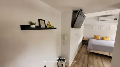 a bedroom with a bed and a tv on a wall at Espectacular departamento en el centro 301 in Cordoba