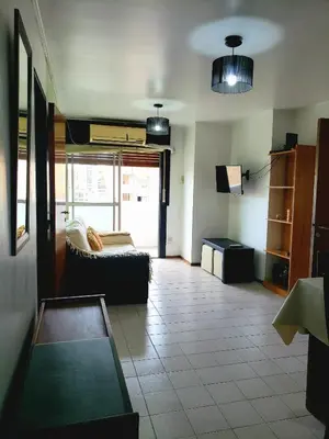 a living room with a couch and a tv at Departamento en Barrio Centro Av Colon in Cordoba