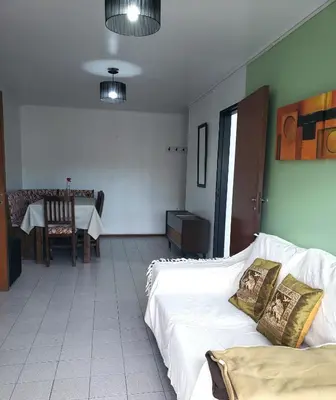 a living room with two beds and a table with a table at Departamento en Barrio Centro Av Colon in Cordoba