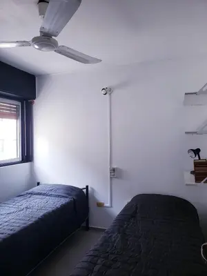 a bedroom with a bed and a ceiling fan at Departamento en Barrio Centro Av Colon in Cordoba