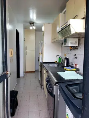 a kitchen with a sink and a stove at Departamento en Barrio Centro Av Colon in Cordoba