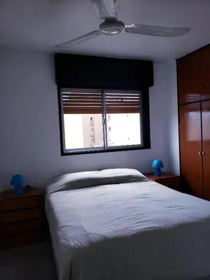 a bedroom with a bed and a window at Departamento en Barrio Centro Av Colon in Cordoba