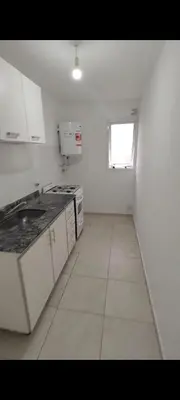 a kitchen with white cabinets and a window at Departamento 1 dormitorio in Cordoba
