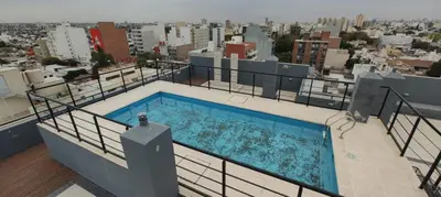 a swimming pool on the roof of a building at Departamento 1 dormitorio in Cordoba