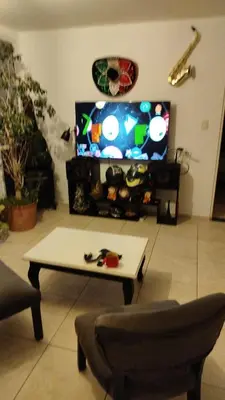a living room with a tv and a coffee table at Departamento 1 dormitorio in Cordoba