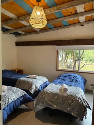 two beds in a room with a ceiling with a window at Rio Dorado Resort in Cavalango