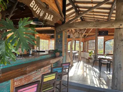 a restaurant with a bar with chairs and tables at Rio Dorado Resort in Cavalango