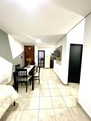 a dining room and living room with a table and chairs at Rincon de Alta Cordoba in Cordoba