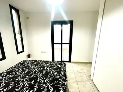 a bedroom with a bed and a light on the ceiling at Rincon de Alta Cordoba in Cordoba