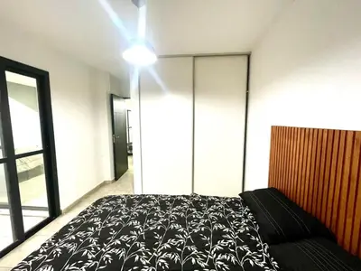 a bedroom with a bed and a large window at Rincon de Alta Cordoba in Cordoba
