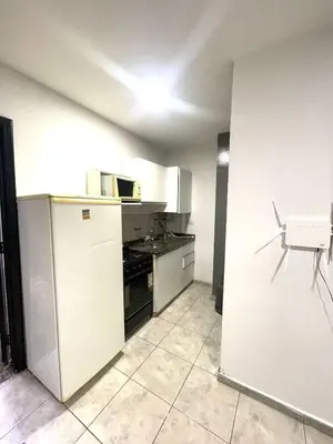 an empty kitchen with a stove and a refrigerator at Rincon de Alta Cordoba in Cordoba