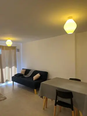 a living room with a couch and a table at Departamento Temporario en Cordoba Capital in Cordoba