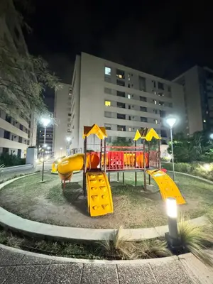 a playground at night with yellow and red equipment at Departamento Temporario en Cordoba Capital in Cordoba