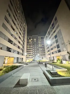 a city street at night with two tall buildings at Departamento Temporario en Cordoba Capital in Cordoba