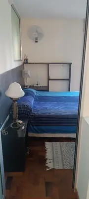 a bedroom with a blue bed and a table with a lamp at Dpto Nueva Cordoba frente Palacio Ferreyra a 100mt Consulado España in Cordoba