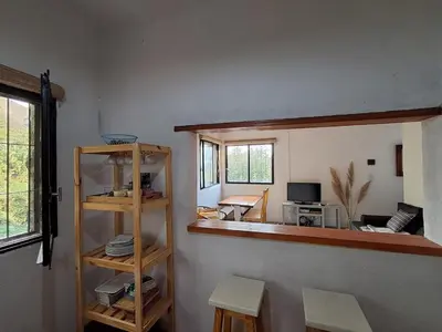 a room with a mirror and a living room at Casa en la montaña, Rincón del Este - Merlo SL in Merlo