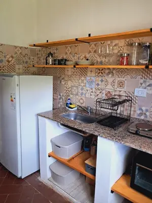 a kitchen with a sink and a white refrigerator at Casa en la montaña, Rincón del Este - Merlo SL in Merlo