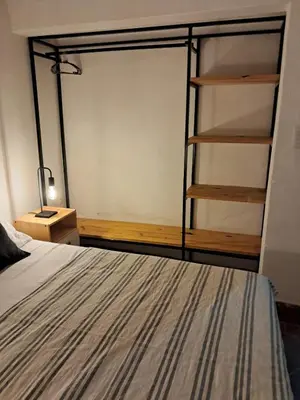a bedroom with a bed and a book shelf at Casa en la montaña, Rincón del Este - Merlo SL in Merlo