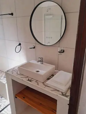 a bathroom with a sink and a mirror at Casa en la montaña, Rincón del Este - Merlo SL in Merlo