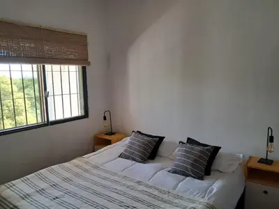 a bedroom with two beds and a window at Casa en la montaña, Rincón del Este - Merlo SL in Merlo