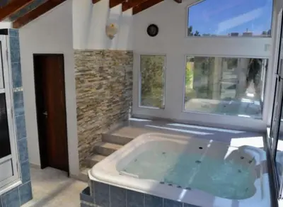 a large bath tub in a room with a window at Cabañas Pio Pio in Merlo