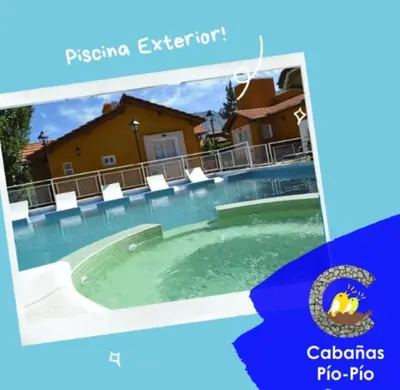 a picture of a swimming pool with chairs in it at Cabañas Pio Pio in Merlo